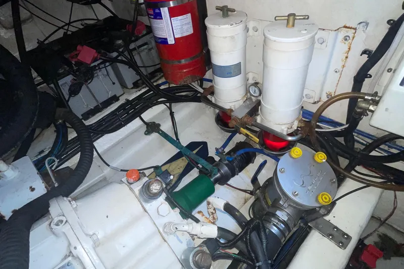 Slide: The Image of Engine room of 2005 Riviera 47 Open Flybridge Series II with filters and fire extinguisher. - 36