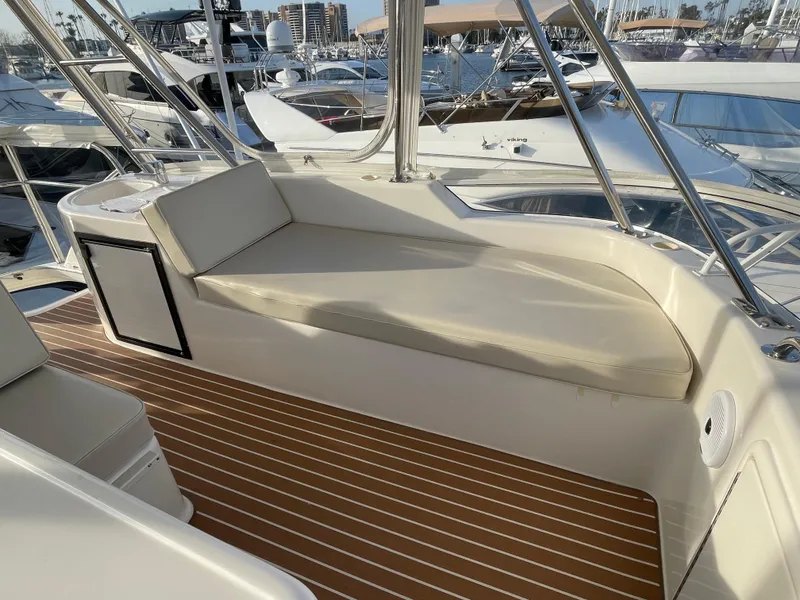 Slide: The Image of 2005 Riviera 47 Open Flybridge Series II interior with cushioned seating and wooden flooring. - 43