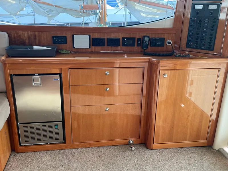 Slide: The Image of 2005 Riviera 47 Open Flybridge Series II interior with wooden cabinetry and built-in appliances. - 47