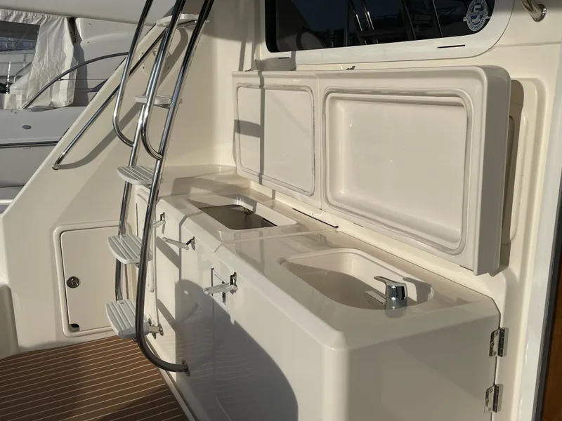 Slide: The Image of 2005 Riviera 47 Open Flybridge Series II yacht with outdoor sink and storage area. - 49