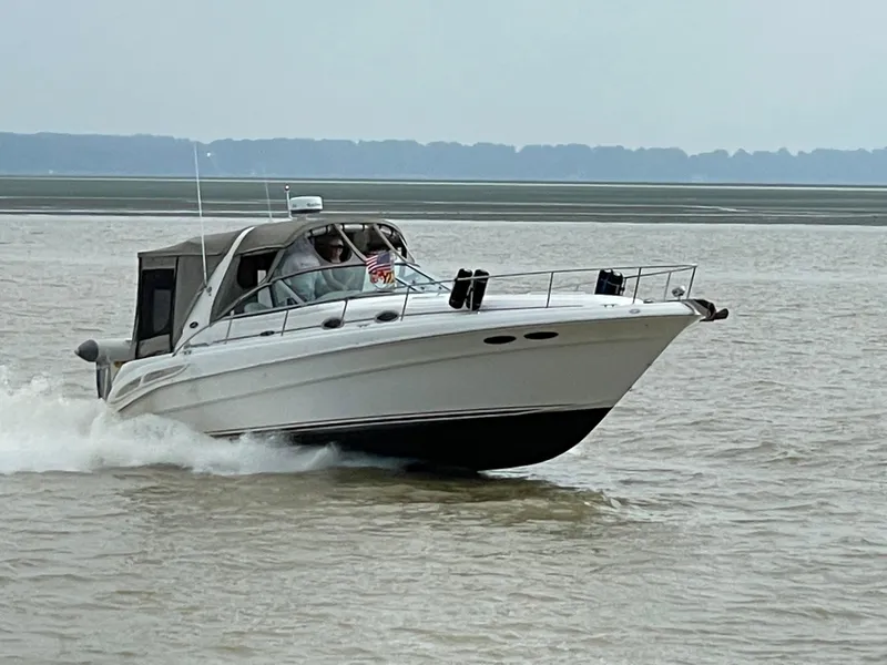 The Image of 2001 Sea Ray 340 Sundancer cruising on open water, side view. - 0