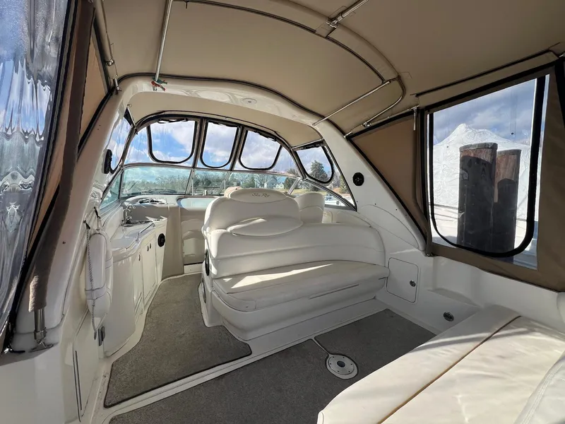 Slide: The Image of Interior of 2001 Sea Ray 340 Sundancer boat with beige seating and windows. - 12
