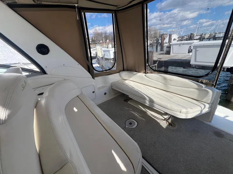 Slide: The Image of Interior view of 2001 Sea Ray 340 Sundancer boat with beige seating and windows. - 13