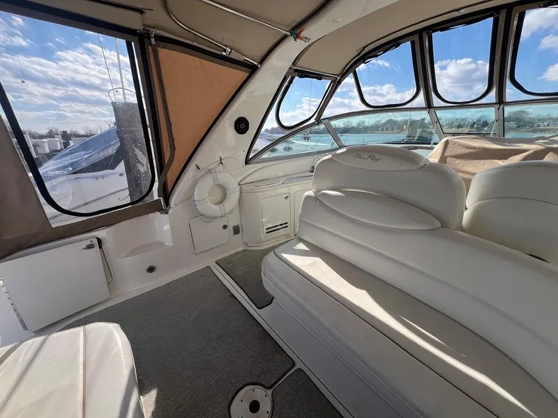 Slide: The Image of Interior of 2001 Sea Ray 340 Sundancer yacht with white seating and panoramic windows. - 14
