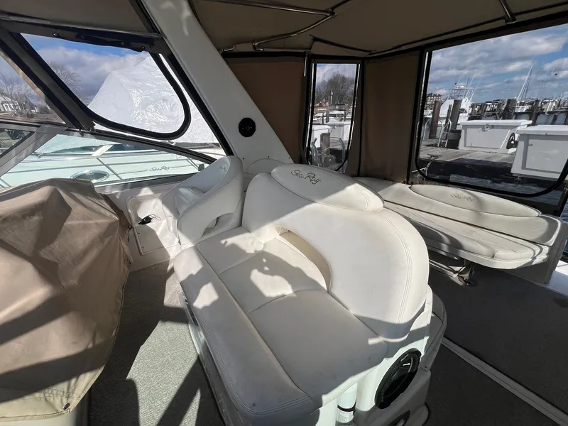 Slide: The Image of 2001 Sea Ray 340 Sundancer interior with white seating and large windows. - 18