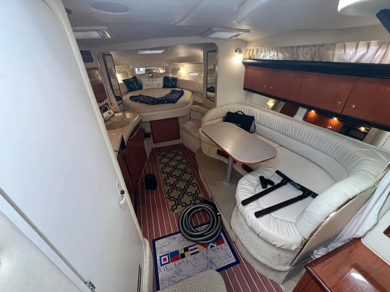 Slide: The Image of Interior of 2001 Sea Ray 340 Sundancer yacht with elegant seating and dining area. - 19