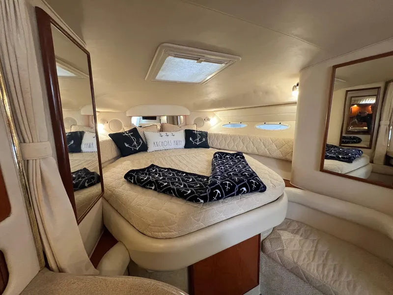 Slide: The Image of Luxurious interior of 2001 Sea Ray 340 Sundancer yacht with cozy bed and nautical decor. - 21