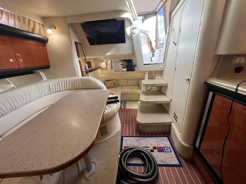 Slide: The Image of Interior of 2001 Sea Ray 340 Sundancer yacht with elegant seating and wooden accents. - 23