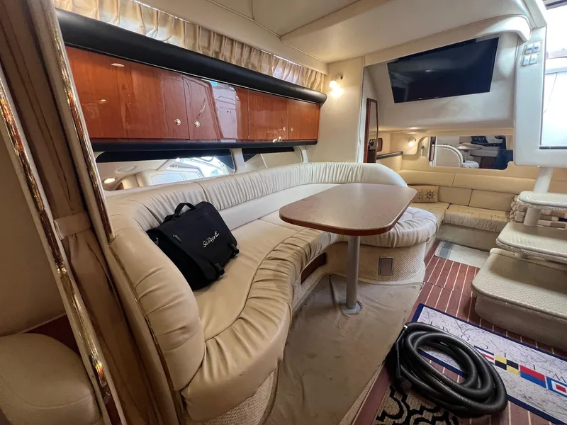 Slide: The Image of Luxurious interior of 2001 Sea Ray 340 Sundancer yacht with plush seating and wooden cabinetry. - 27