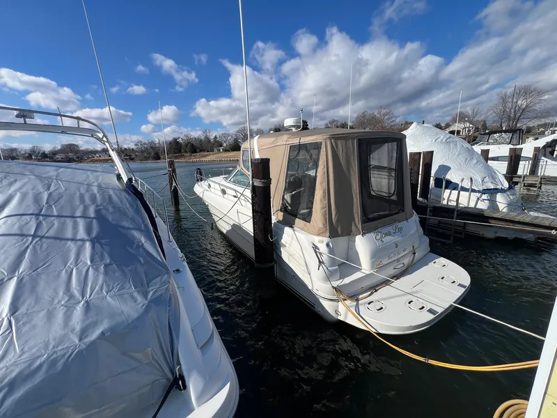 Slide: The Image of 2001 Sea Ray 340 Sundancer docked at marina under blue sky. - 3