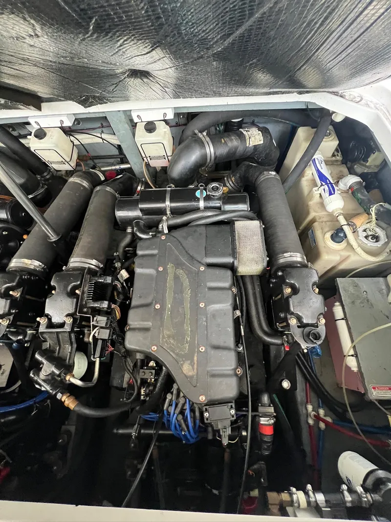 Slide: The Image of Engine compartment of a 2001 Sea Ray 340 Sundancer boat, showcasing mechanical components. - 31