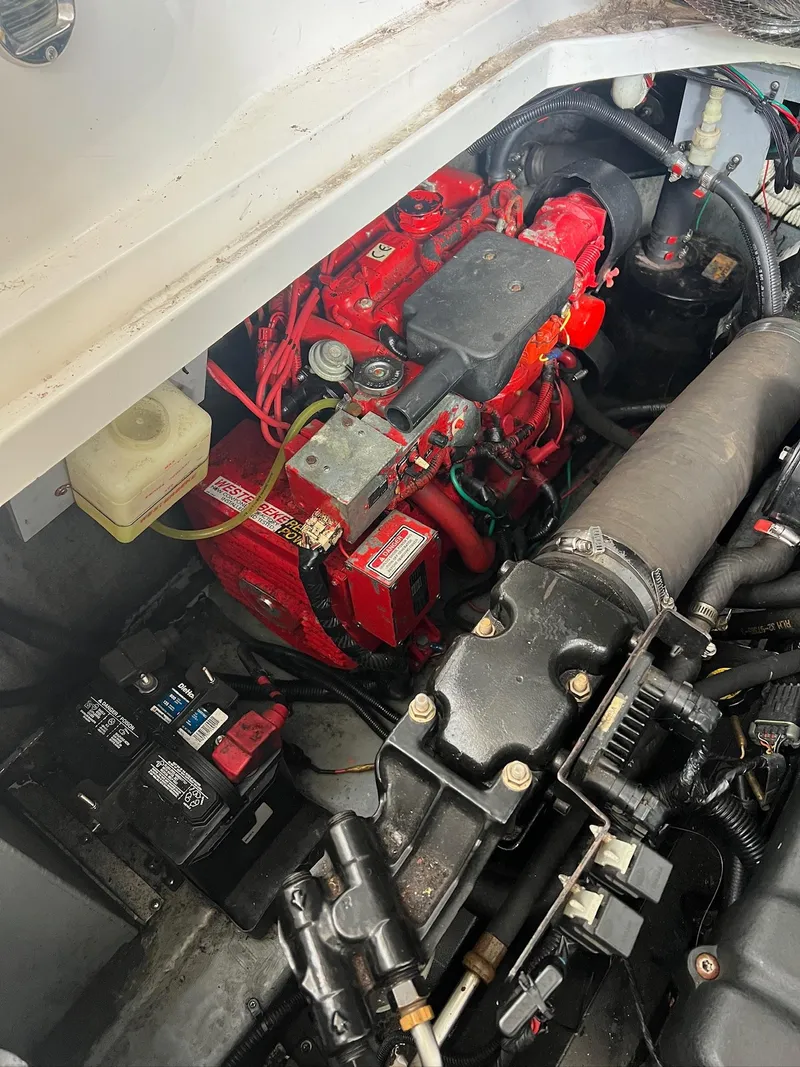 Slide: The Image of Engine compartment of a 2001 Sea Ray 340 Sundancer boat, featuring a red engine. - 33