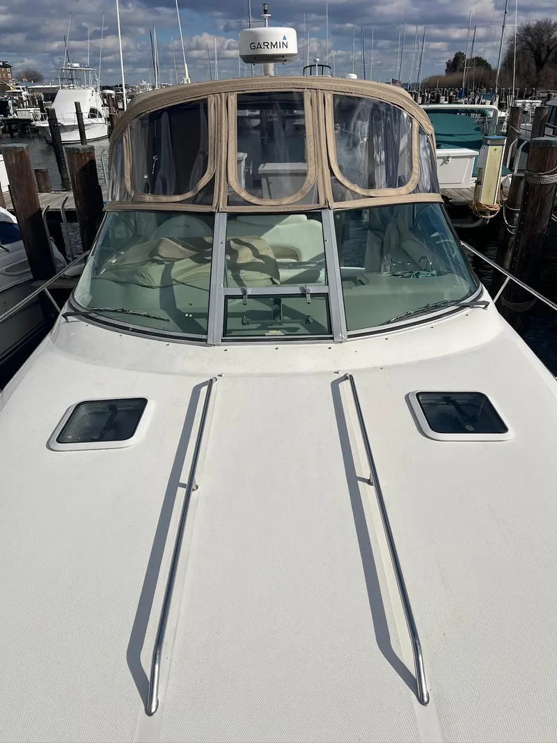 Slide: The Image of 2001 Sea Ray 340 Sundancer boat docked, featuring a sleek design and spacious deck. - 36