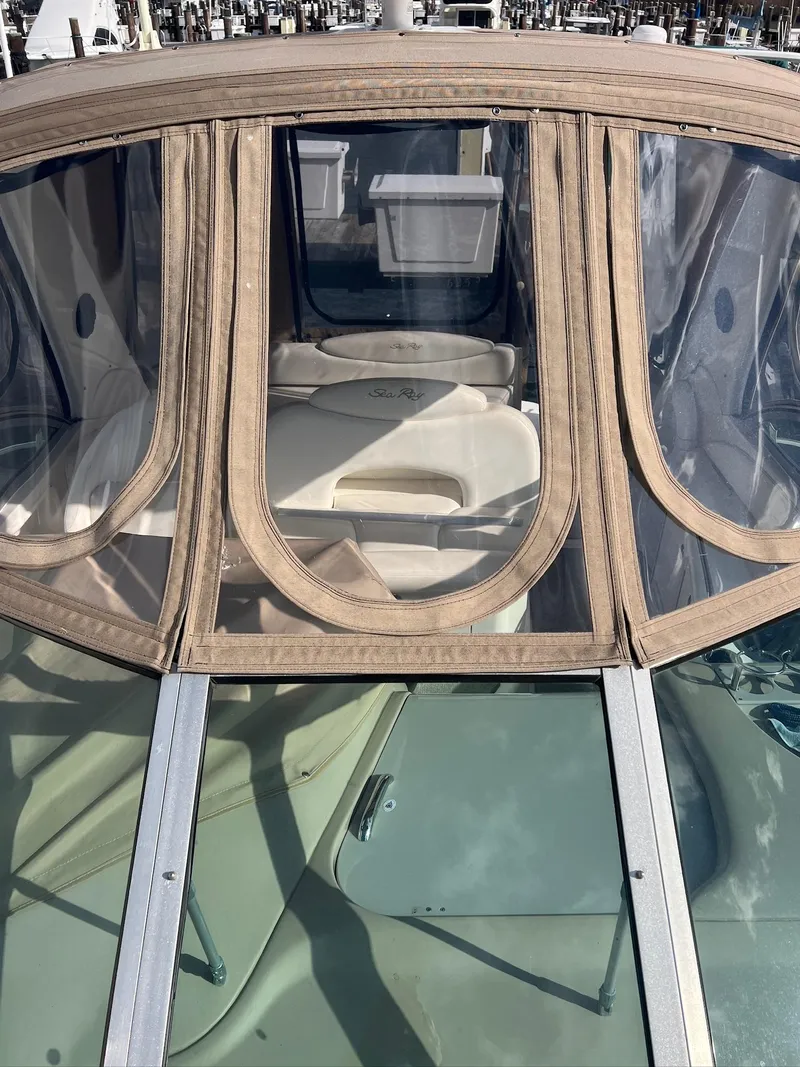 Slide: The Image of 2001 Sea Ray 340 Sundancer boat with beige canopy and clear windows. - 37