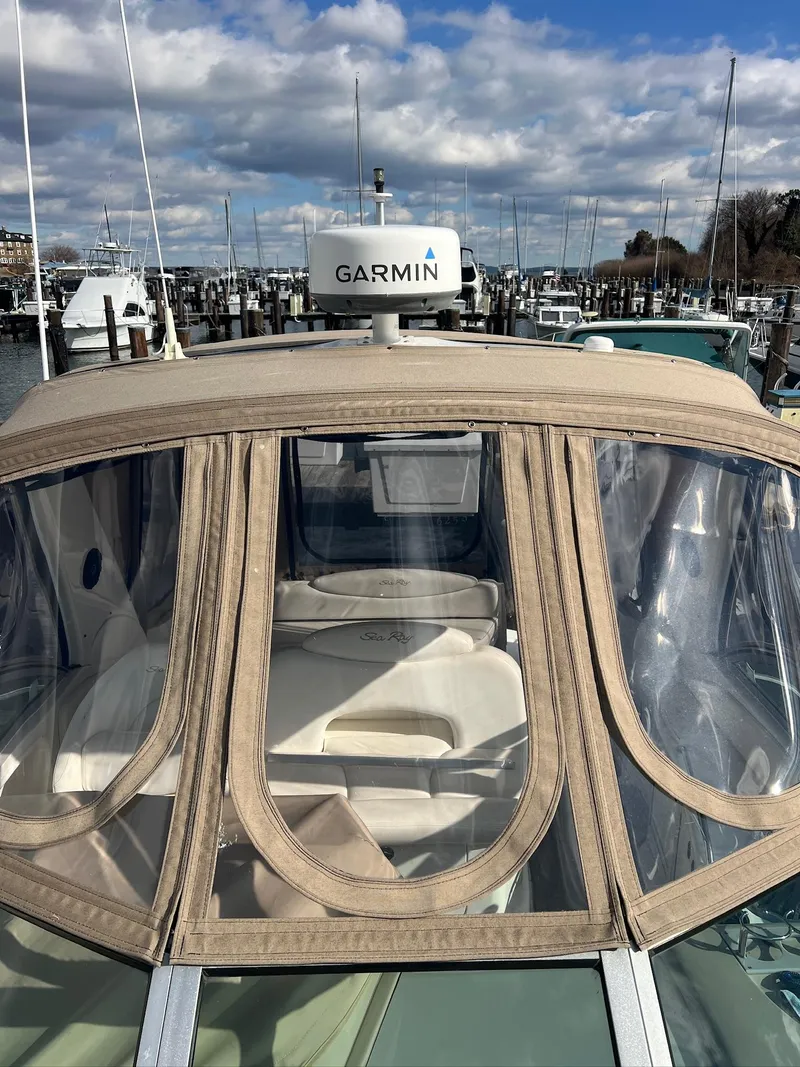 Slide: The Image of 2001 Sea Ray 340 Sundancer with Garmin radar, docked at a marina under a cloudy sky. - 38