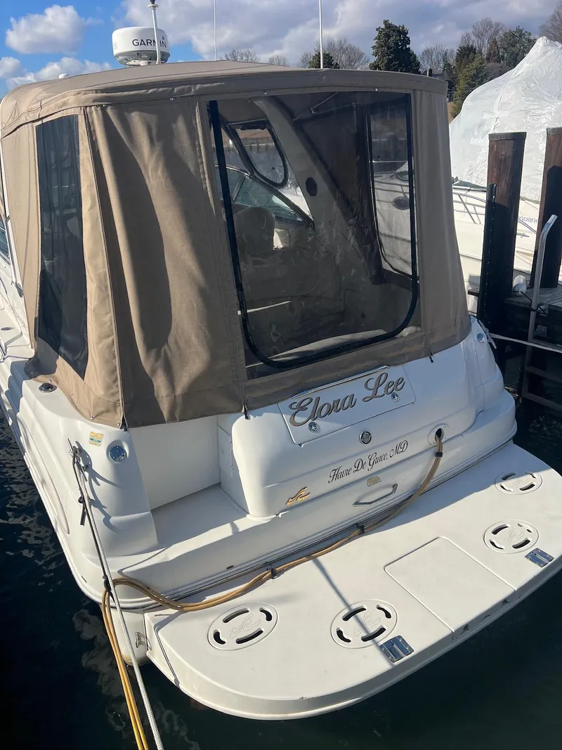 Slide: The Image of 2001 Sea Ray 340 Sundancer docked with beige canopy and clear windows. - 5