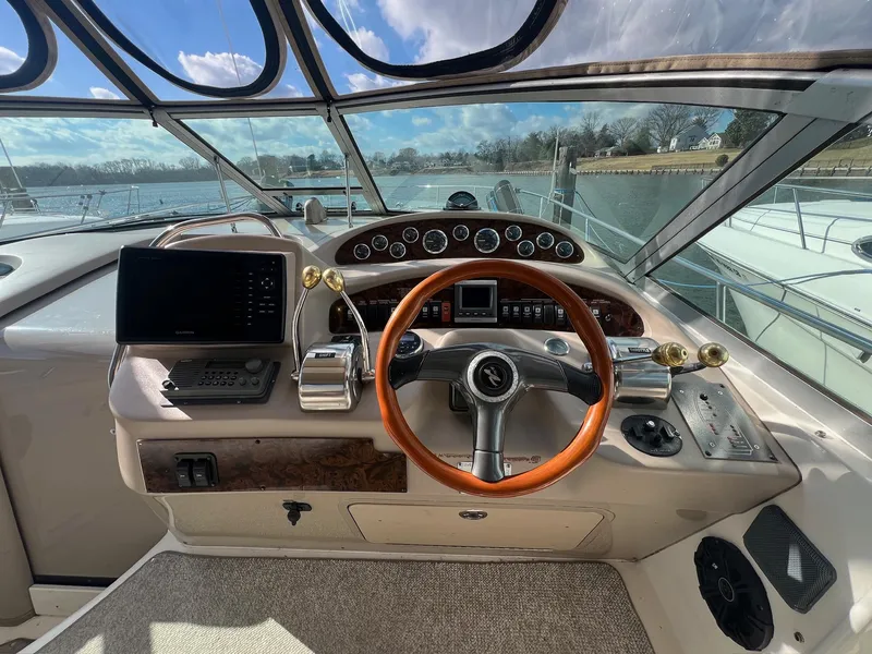 Slide: The Image of 2001 Sea Ray 340 Sundancer helm with wooden steering wheel and modern navigation equipment. - 6