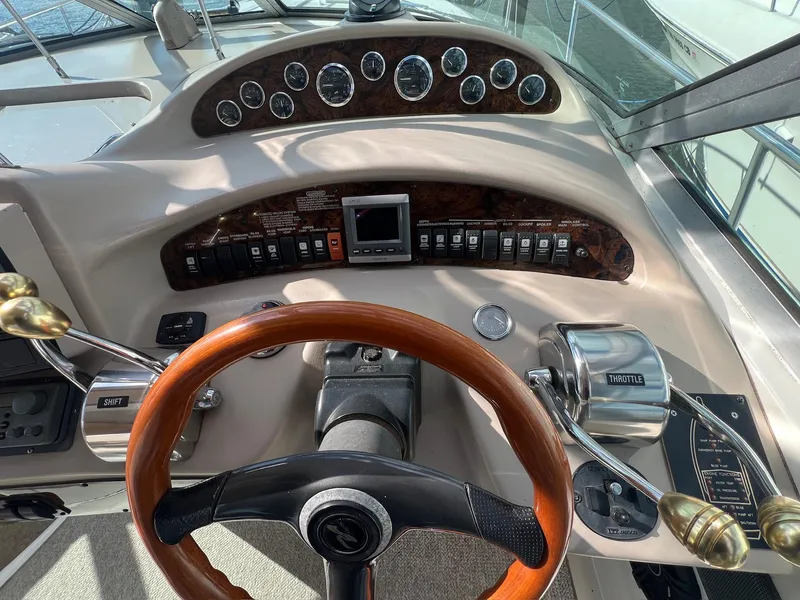 Slide: The Image of 2001 Sea Ray 340 Sundancer helm with wood steering wheel and control panel. - 7