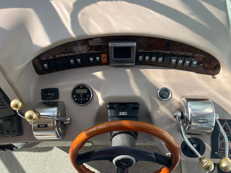 Slide: The Image of Control panel of a 2001 Sea Ray 340 Sundancer boat with steering wheel and throttle controls. - 8