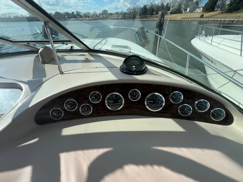 Slide: The Image of 2001 Sea Ray 340 Sundancer dashboard with gauges, docked on a sunny day. - 9
