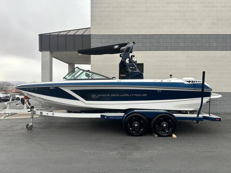 Slide: The Image of 2019 Nautique Super Air Nautique GS22 boat on trailer, parked outdoors. - 1