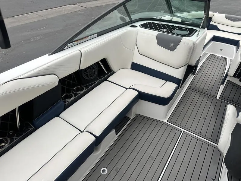 Slide: The Image of 2019 Nautique Super Air Nautique GS22 interior with white and navy seating, sleek design. - 11