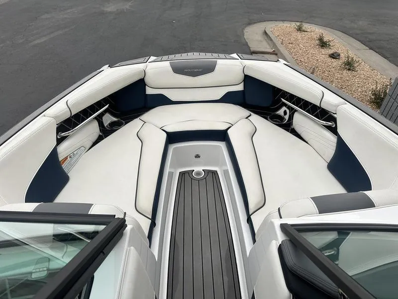 Slide: The Image of 2019 Nautique Super Air Nautique GS22 boat interior with white and navy seating. - 13