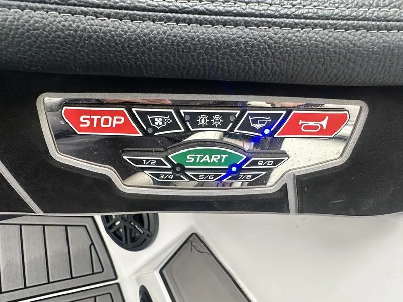 Slide: The Image of Control panel of 2019 Nautique Super Air Nautique GS22 boat with start and stop buttons. - 2