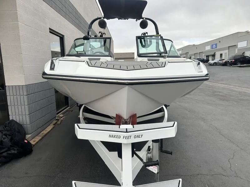 Slide: The Image of 2019 Nautique Super Air Nautique GS22 boat on trailer, parked outside a building. - 5