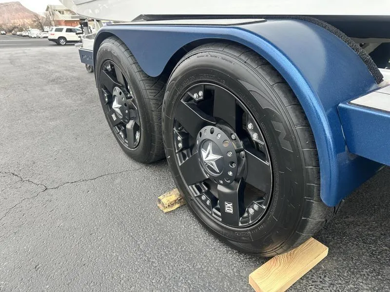 Slide: The Image of 2019 Nautique Super Air Nautique GS22 trailer wheels on wooden blocks. - 6