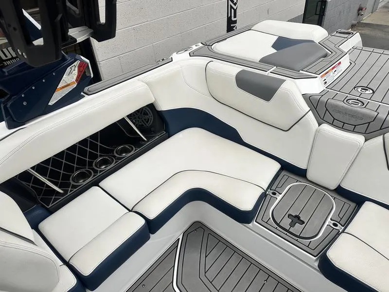 Slide: The Image of 2019 Nautique Super Air Nautique GS22 interior with white and navy seating. - 9