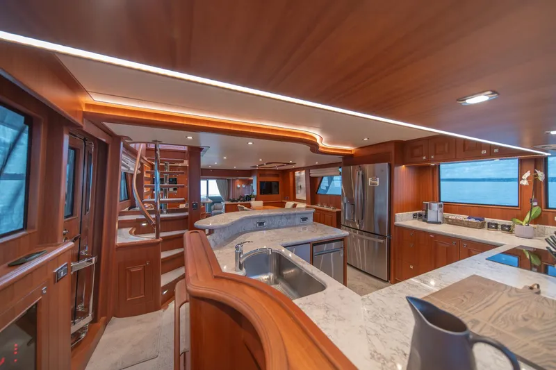 Slide: The Image of Luxurious interior of 2022 Hampton Endurance 750 LRC yacht with modern kitchen and wooden finishes. - 12