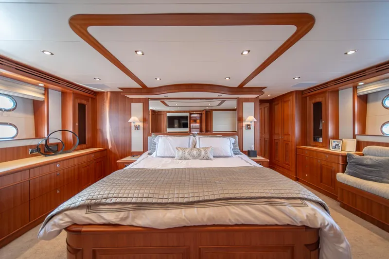 Slide: The Image of Luxurious master bedroom in 2022 Hampton Endurance 750 LRC yacht, featuring elegant wood finishes. - 20