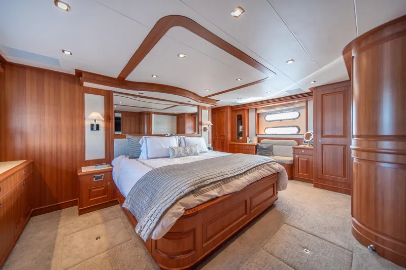 Slide: The Image of Luxurious bedroom interior of 2022 Hampton Endurance 750 LRC yacht with elegant wood finishes. - 21