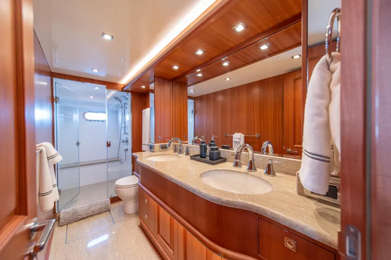 Slide: The Image of Luxurious bathroom in 2022 Hampton Endurance 750 LRC yacht with wood accents and modern fixtures. - 22