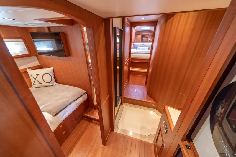 Slide: The Image of Luxurious interior of 2022 Hampton Endurance 750 LRC yacht with wood paneling and cozy bedding. - 24