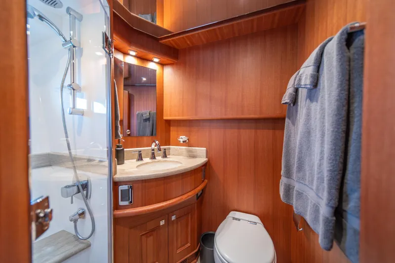 Slide: The Image of Luxurious bathroom in 2022 Hampton Endurance 750 LRC yacht with wood paneling and modern fixtures. - 27