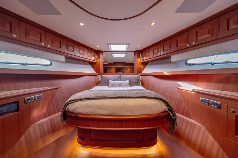 Slide: The Image of Luxurious bedroom interior of 2022 Hampton Endurance 750 LRC yacht with wood paneling. - 28