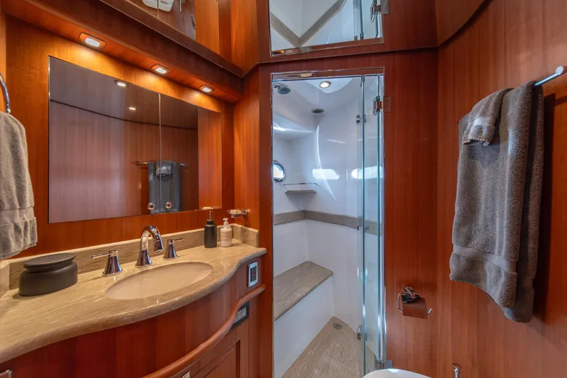 Slide: The Image of Luxurious bathroom in 2022 Hampton Endurance 750 LRC yacht with wood accents and modern fixtures. - 30