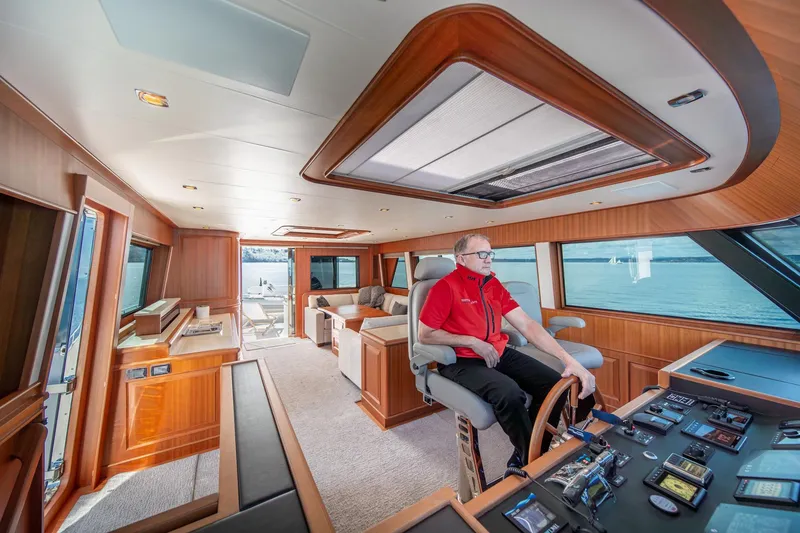 Slide: The Image of Interior of 2022 Hampton Endurance 750 LRC yacht with captain at helm, featuring luxurious design. - 32