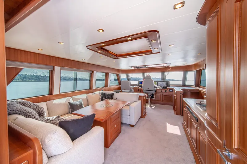 Slide: The Image of Luxurious interior of 2022 Hampton Endurance 750 LRC yacht with plush seating and panoramic windows. - 33