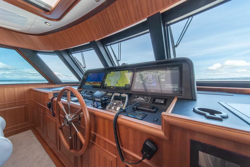 Slide: The Image of 2022 Hampton Endurance 750 LRC yacht helm with advanced navigation systems and wooden finish. - 36