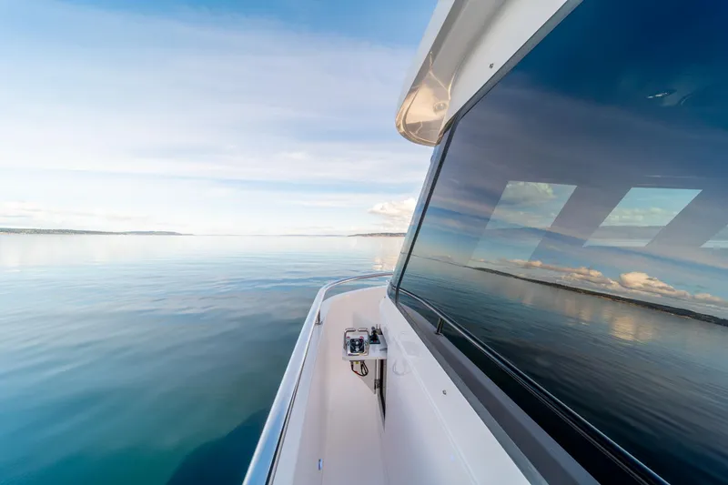 Slide: The Image of 2022 Hampton Endurance 750 LRC yacht cruising on calm waters. - 39