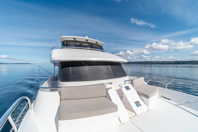 Slide: The Image of 2022 Hampton Endurance 750 LRC yacht on calm water under blue sky. - 40