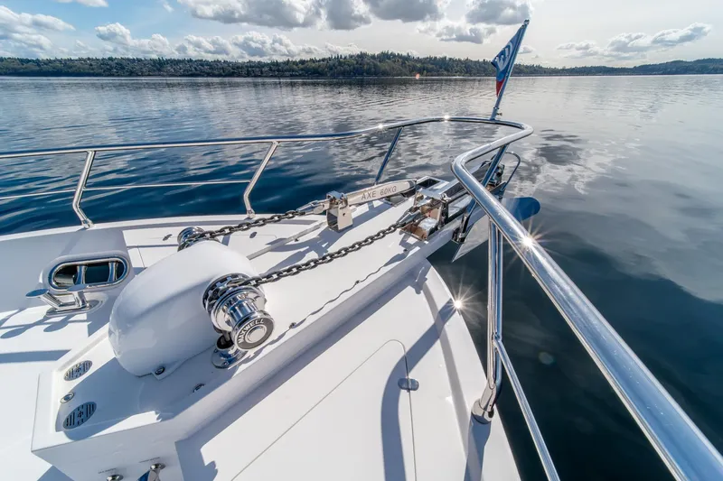 Slide: The Image of Bow of 2022 Hampton Endurance 750 LRC yacht on calm water, featuring anchor chain. - 41