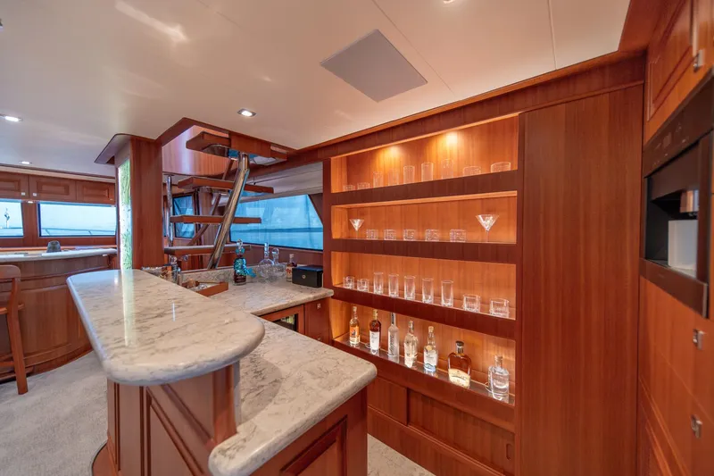 Slide: The Image of Luxurious interior of 2022 Hampton Endurance 750 LRC yacht with elegant bar and glass shelving. - 9