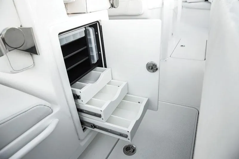 Slide: The Image of 2024 Fountain 34 CC boat interior with open storage compartments and drawers. - 12