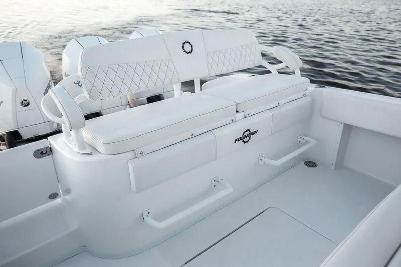Slide: The Image of 2024 Fountain 34 CC boat interior with white seating and ocean backdrop. - 13