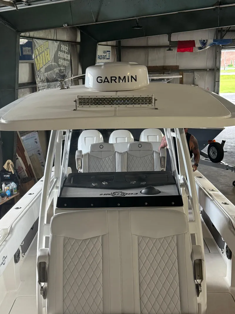 Slide: The Image of 2023 Fountain 34 CC boat with Garmin equipment in a garage setting. - 14