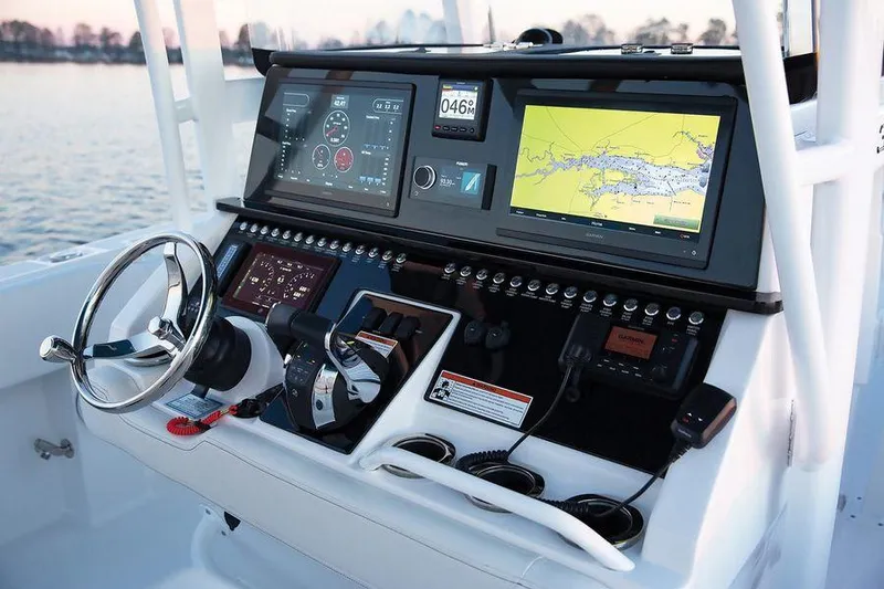 Slide: The Image of 2024 Fountain 34 CC boat dashboard with advanced navigation and control systems. - 2